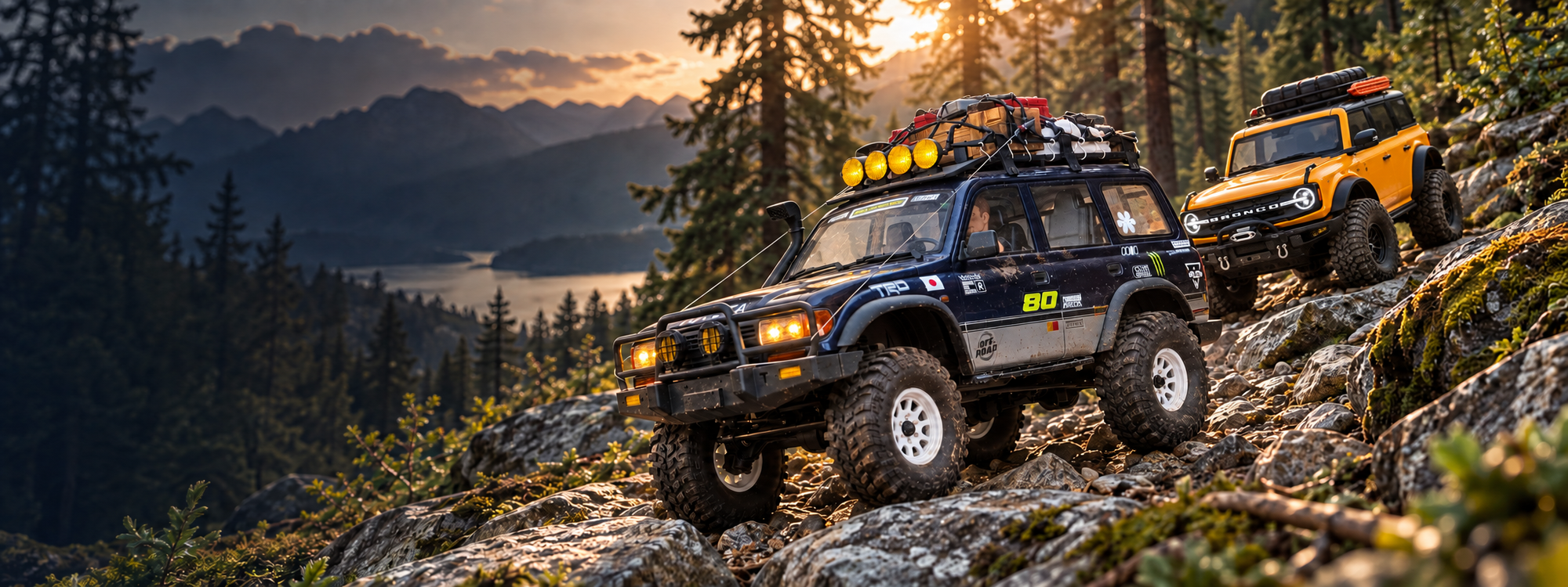 Upgraded navy and silver FMS LC80 leading a yellow Traxxas Bronco down a rocky forest trail